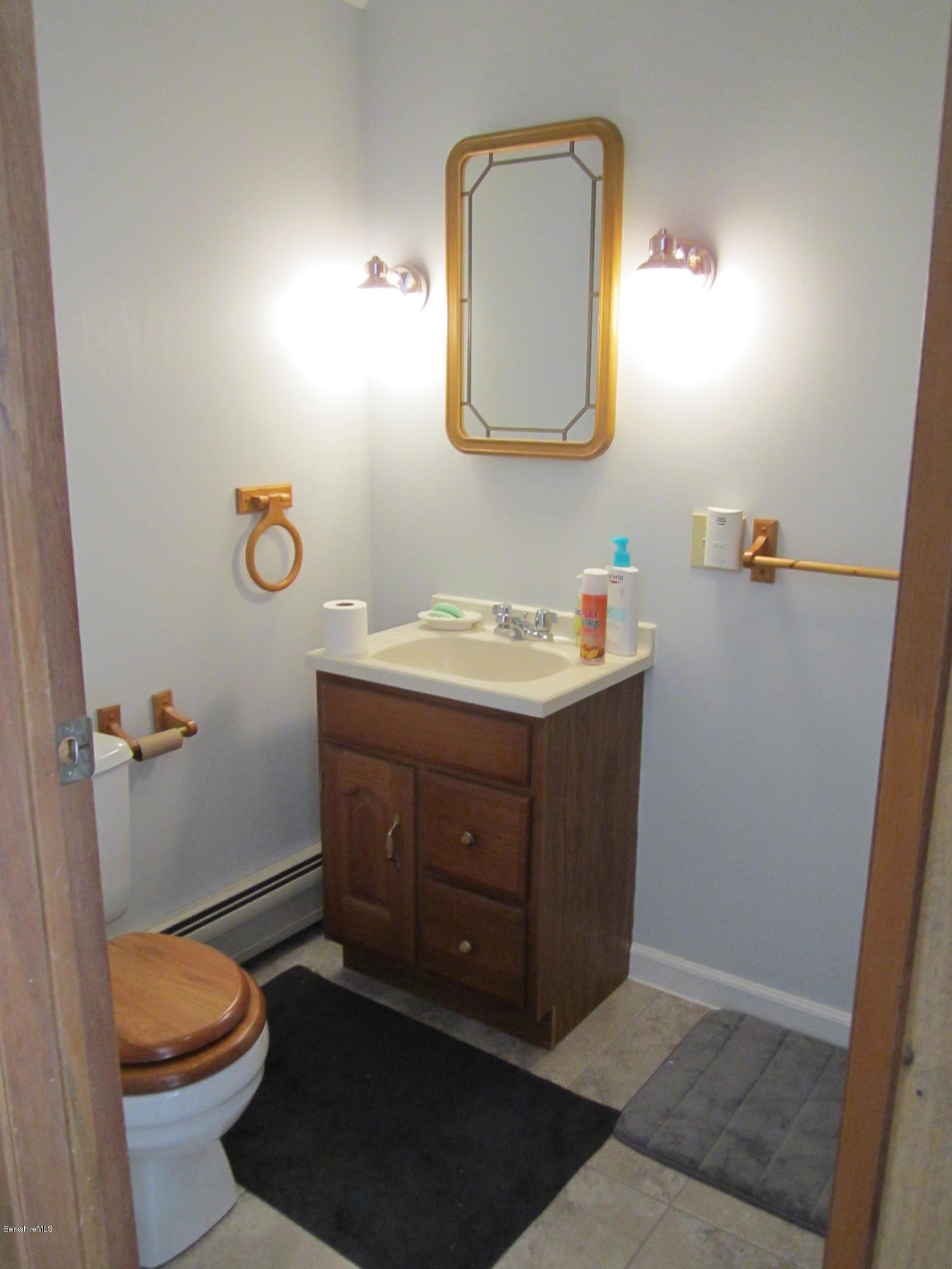 711 Middle Road Clarksburg, MA 01247 - Photo 9 of 10 a bathroom with a sink vanity mirror and toilet