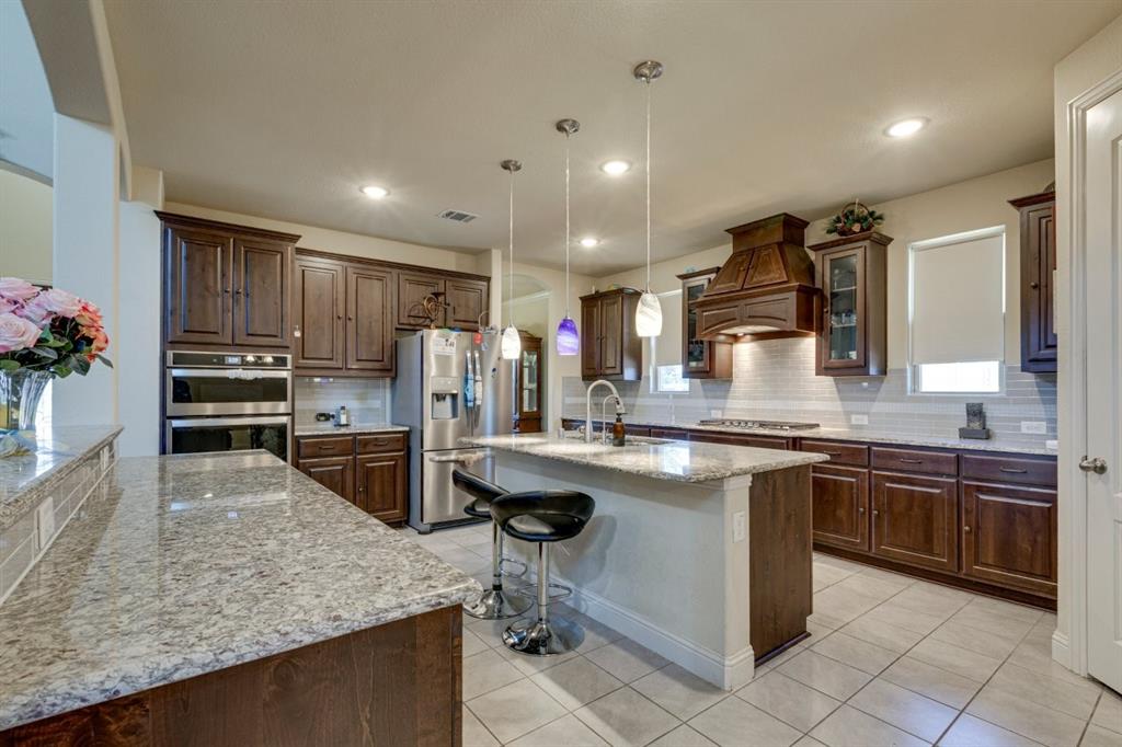 336 Red Hill Road Sunnyvale, TX 75182 - Photo 10 of 36 a kitchen with stainless steel appliances granite countertop sink stove top oven and microwave