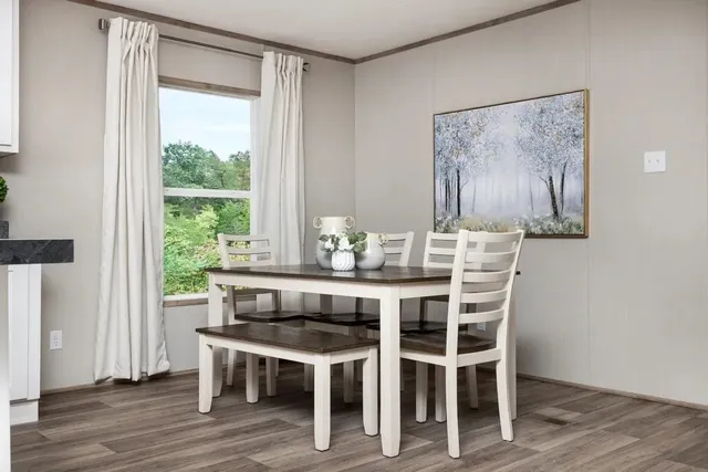 a view of a dining room with furniture window and wooden floor