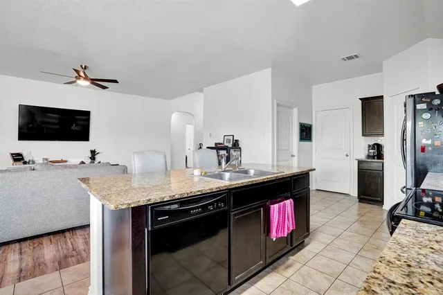 a kitchen with stainless steel appliances a sink stove and refrigerator