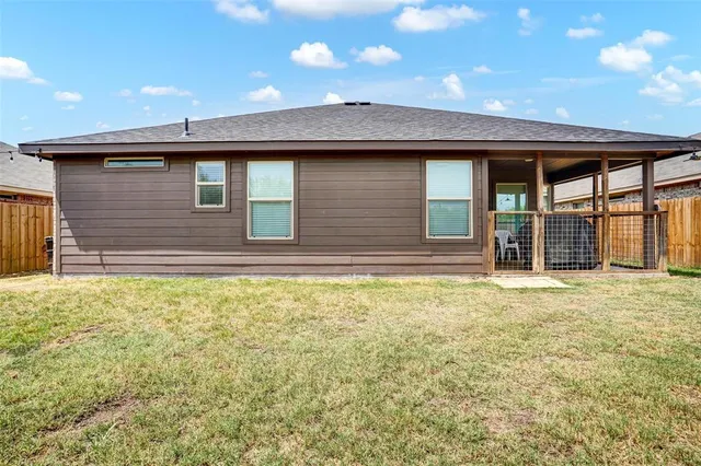 a view of a house with a backyard and a window