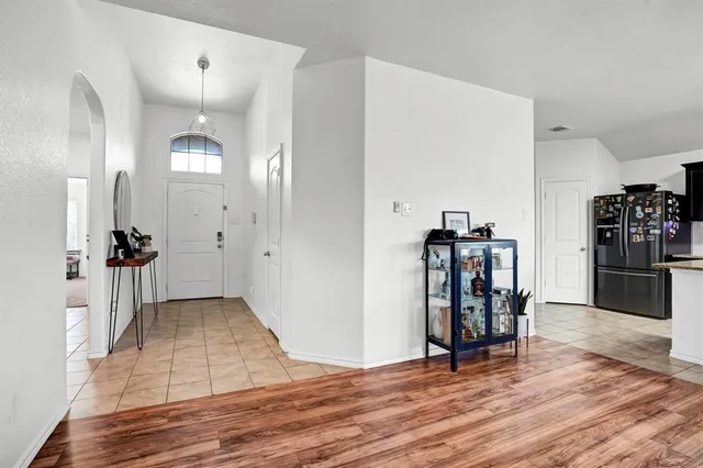 an empty room with wooden floor and furniture
