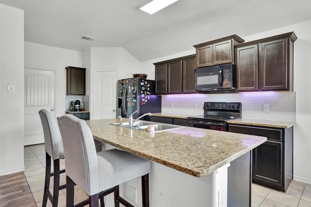 a kitchen with a stove a sink and a refrigerator