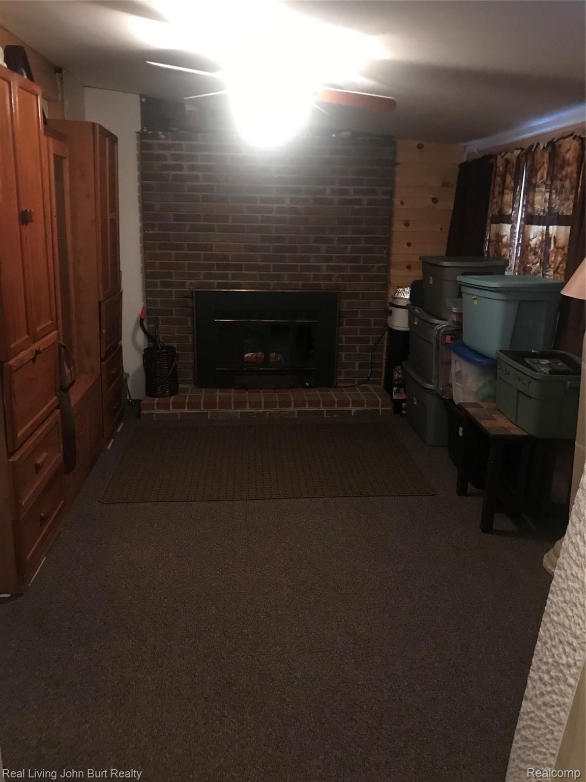3338 West Drahner Road Oxford, MI 48371 - Photo 20 of 21 fireplace in 3 season room