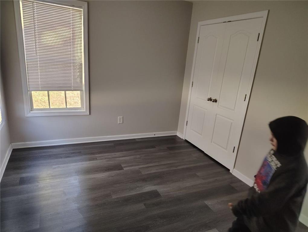 85 Hollow Court Covington, GA 30016 - Photo 9 of 9 a view of an empty room with wooden floor and a window
