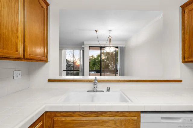 a kitchen with stainless steel appliances white cabinets and a refrigerator