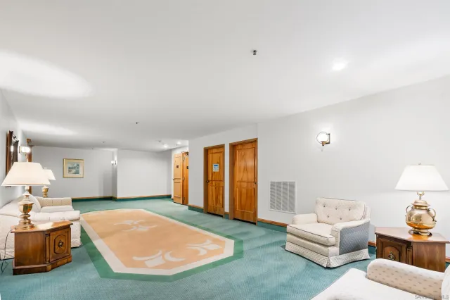 a view of a tennis court with a fountain in the background
