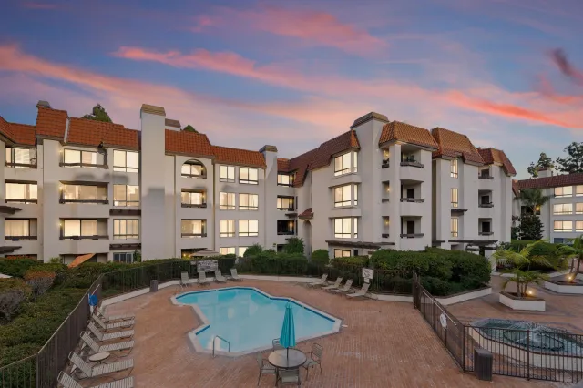 a large building with a swimming pool and outdoor seating