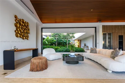 a living room with fireplace furniture and a large window