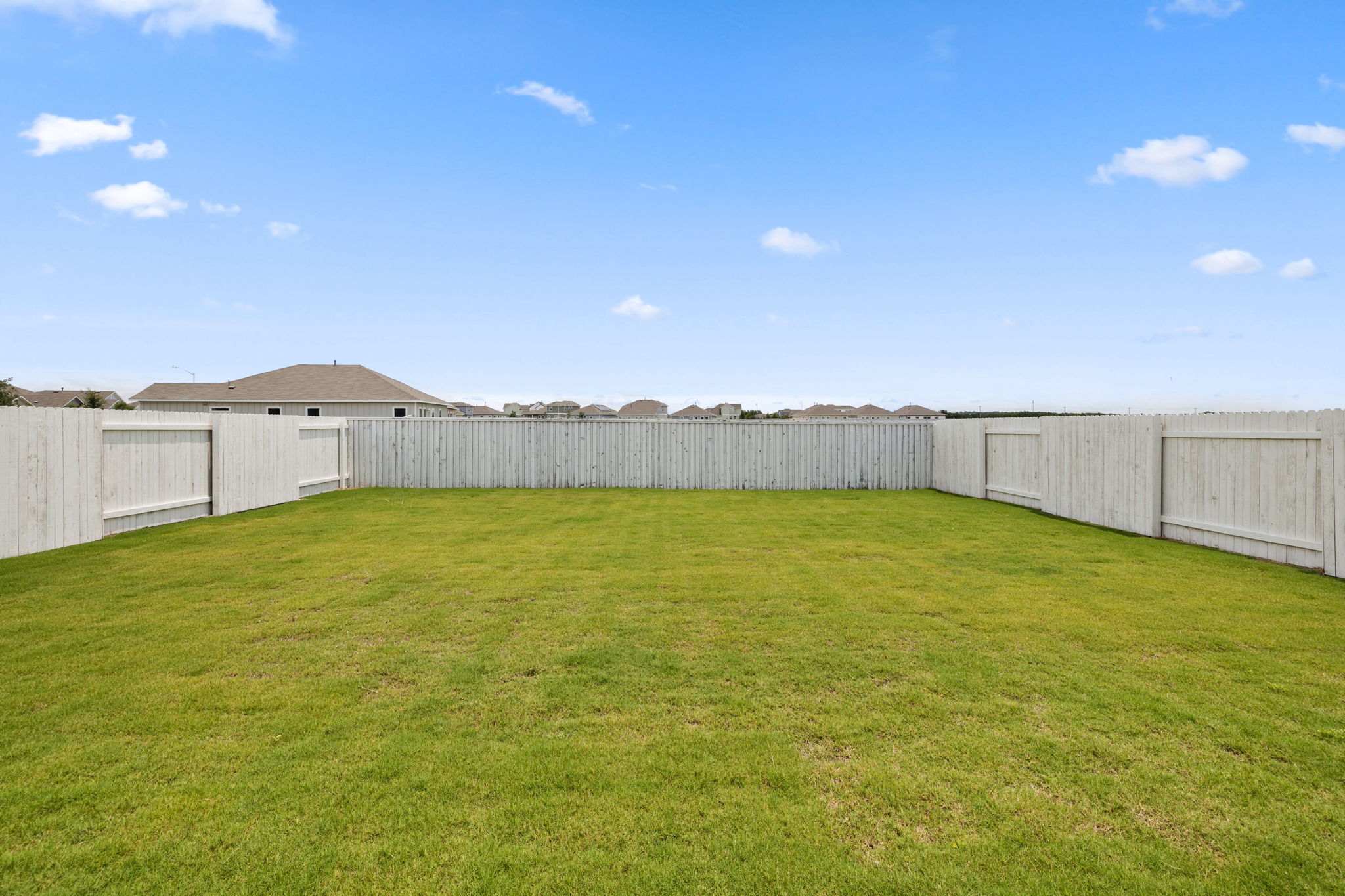 2460 Winding Creek Road Kyle, TX 78640 - Photo 18 of 20 A spacious, green yard awaits your personal touch, fully enclosed for privacy.