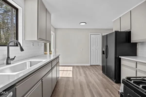 a kitchen with a sink stove and refrigerator