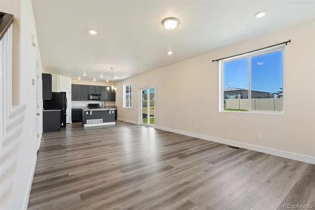 a view of kitchen and refrigerator in a room