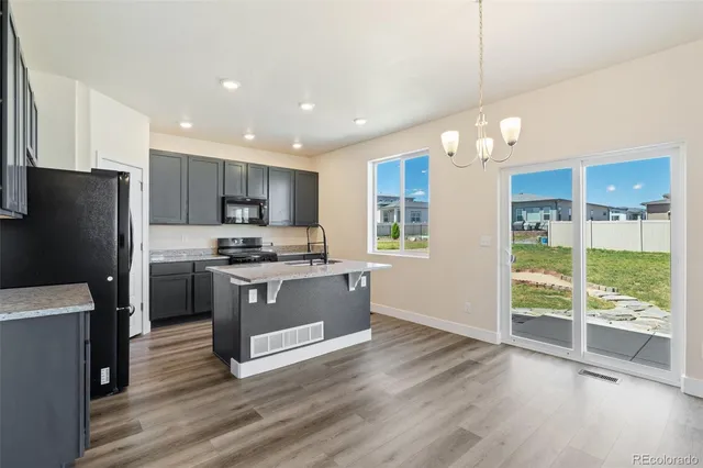 a kitchen with a refrigerator a sink and cabinets