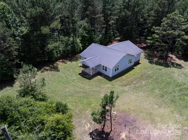 aerial view of a house with a yard