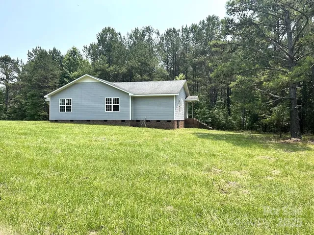a front view of house with green space