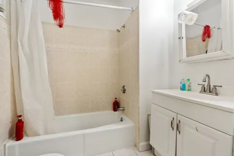 a bathroom with a bathtub a sink and a shower curtain