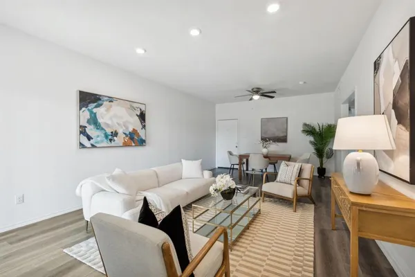 a living room with furniture and a lamp