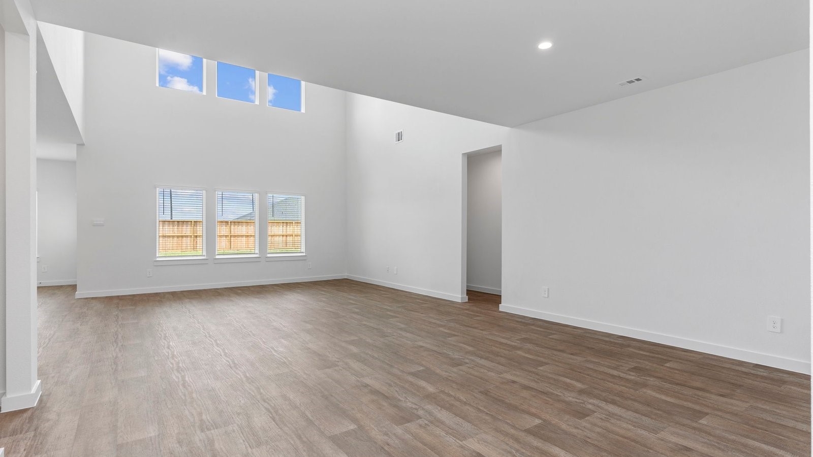 6120 Cherry Mdws Street Rosenberg, TX 77469 - Photo 11 of 39 a view of an empty room with wooden floor and a window