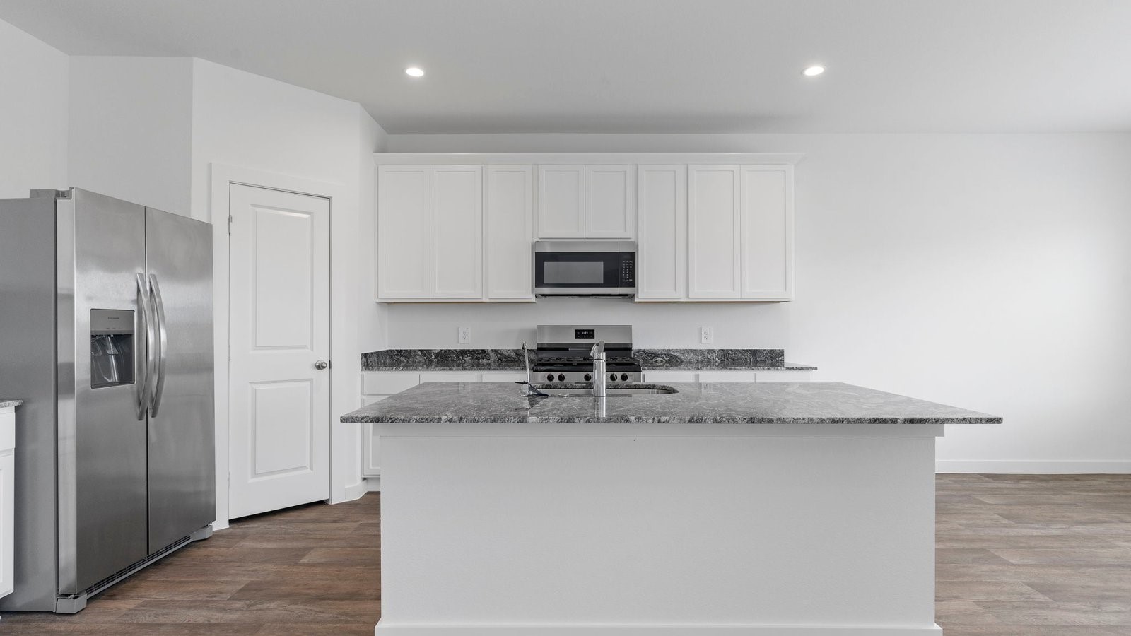 6120 Cherry Mdws Street Rosenberg, TX 77469 - Photo 15 of 39 a kitchen with stainless steel appliances granite countertop a refrigerator a sink a stove a microwave and island