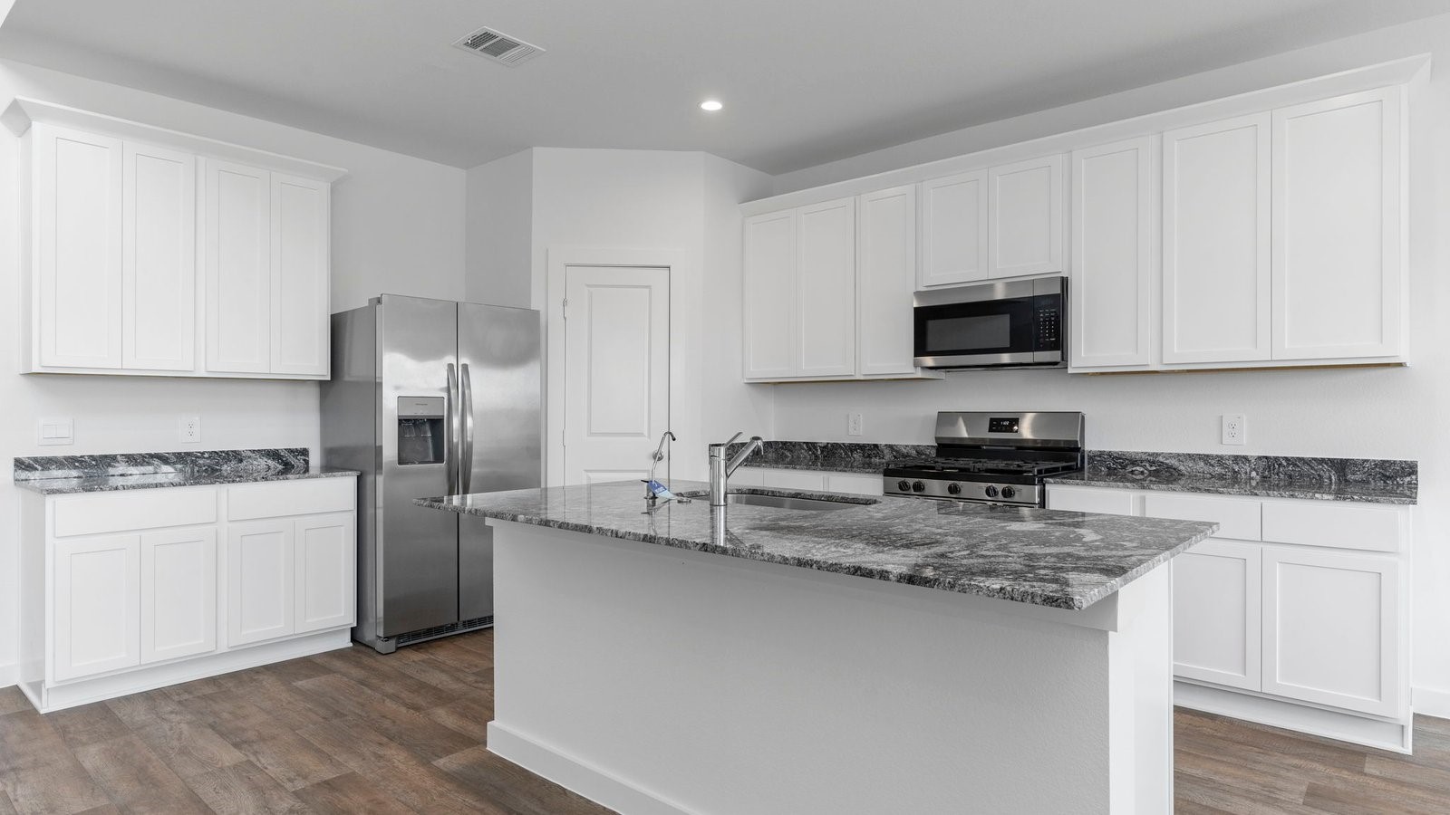 6120 Cherry Mdws Street Rosenberg, TX 77469 - Photo 16 of 39 a kitchen with stainless steel appliances granite countertop a stove a sink a refrigerator a microwave and cabinets