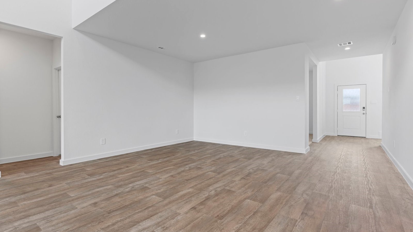 6120 Cherry Mdws Street Rosenberg, TX 77469 - Photo 8 of 39 a view of an empty room with wooden floor and a window