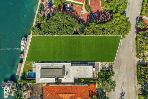 an aerial view of a residential houses with outdoor space and street view