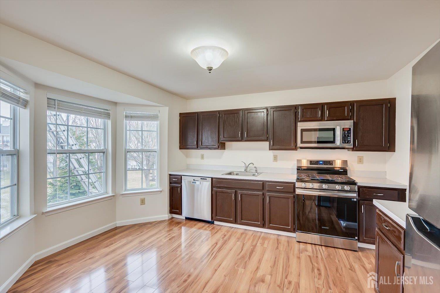 919 Plymouth Road North Brunswick, NJ 08902 - Photo 11 of 33 a kitchen with stainless steel appliances granite countertop a stove and a sink