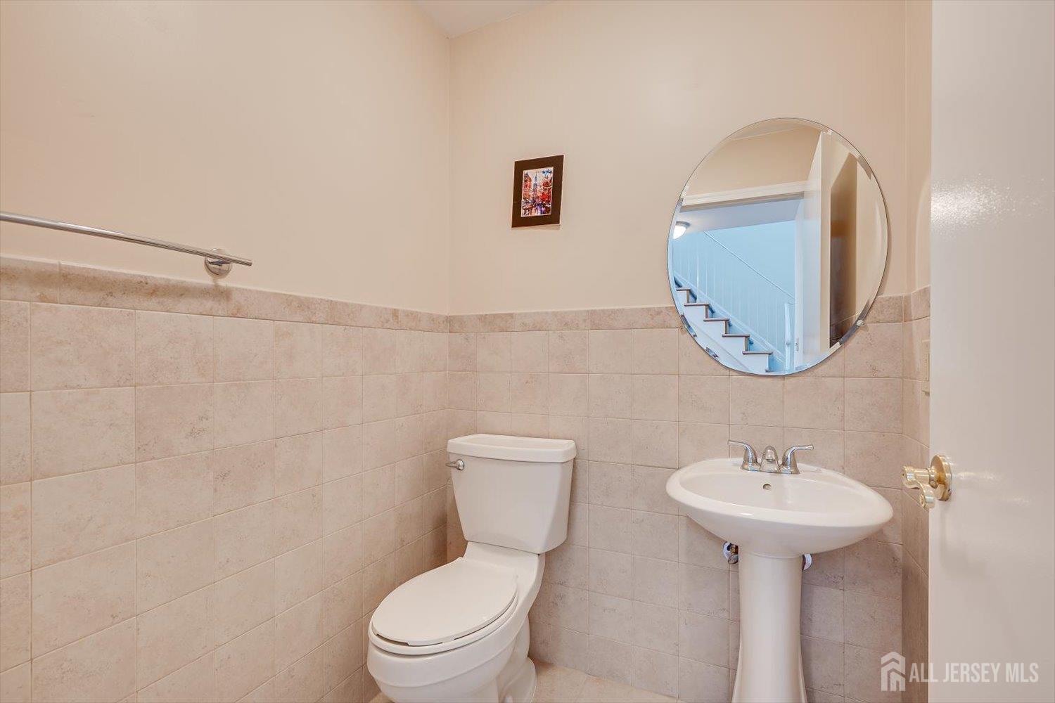 919 Plymouth Road North Brunswick, NJ 08902 - Photo 17 of 33 a bathroom with a toilet sink and mirror