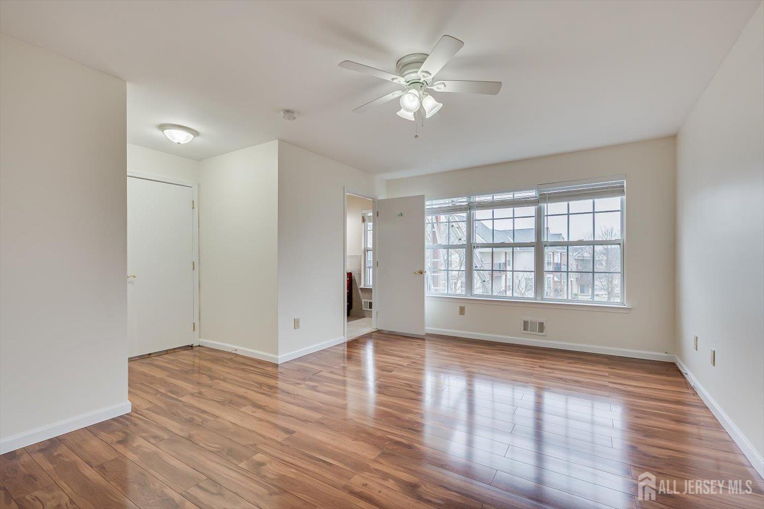 919 Plymouth Road North Brunswick, NJ 08902 - Photo 21 of 33 a view of an empty room with wooden floor and a window