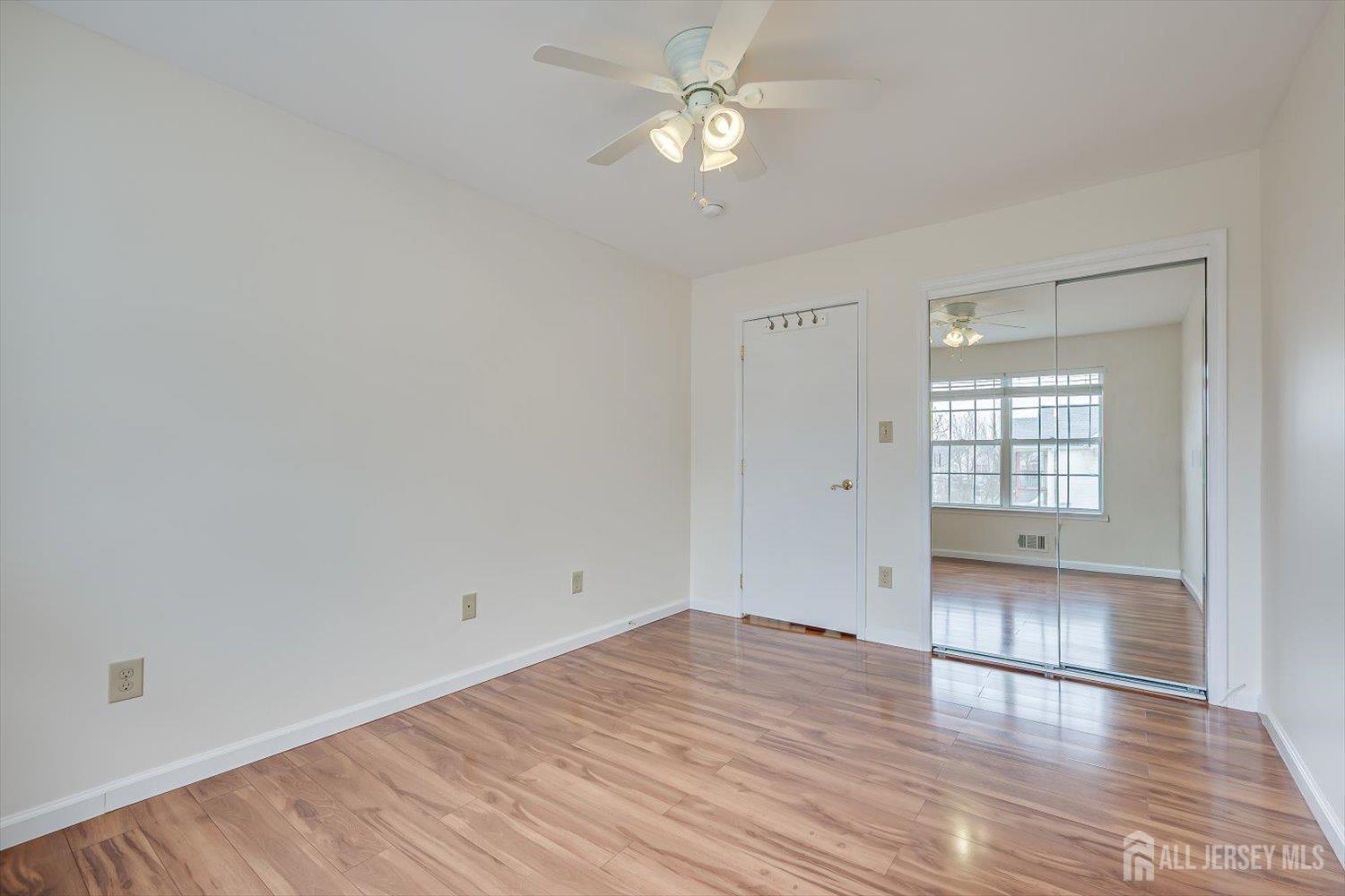 919 Plymouth Road North Brunswick, NJ 08902 - Photo 26 of 33 wooden floor in an empty room with a window