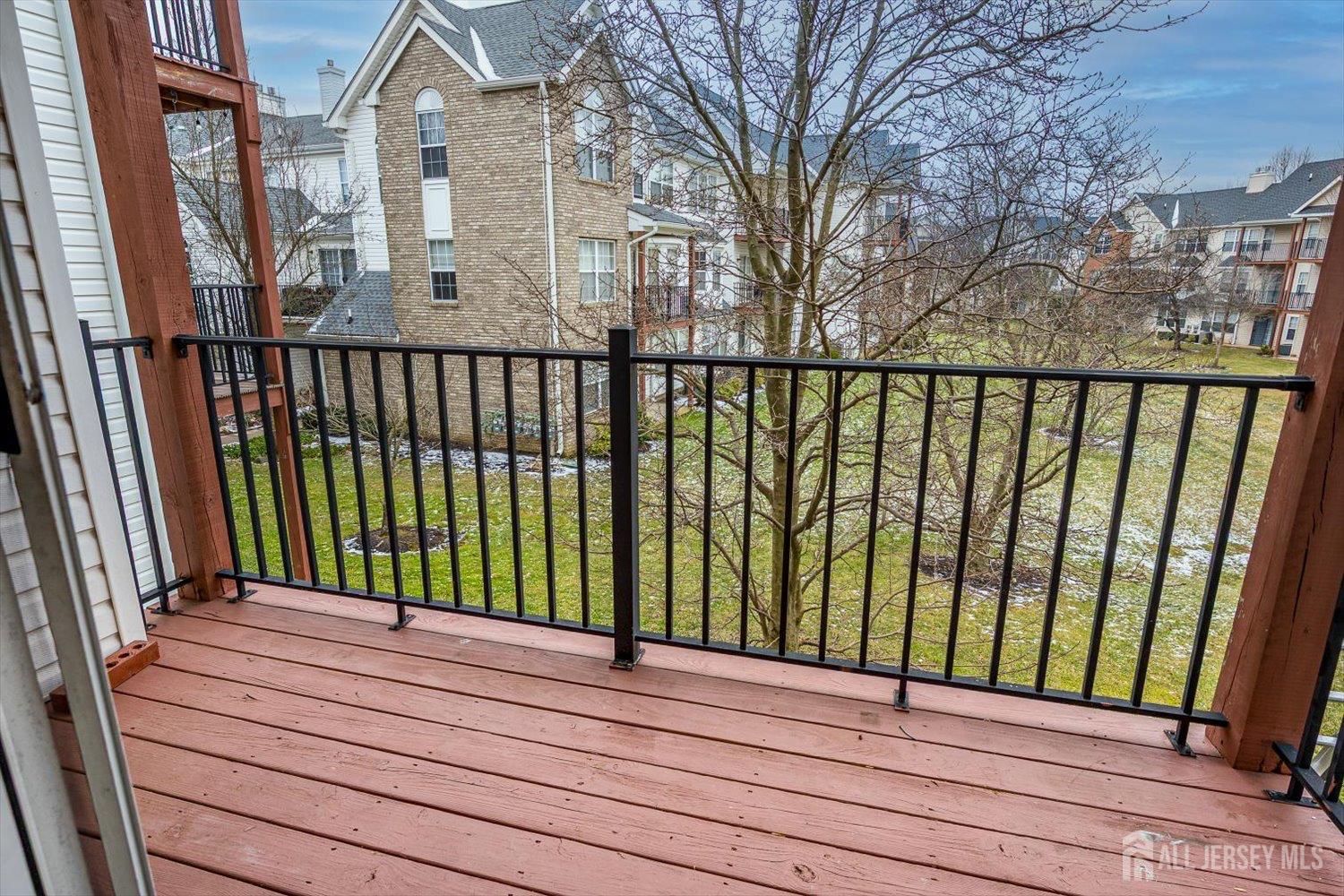 919 Plymouth Road North Brunswick, NJ 08902 - Photo 7 of 33 a view of a balcony with wooden floor