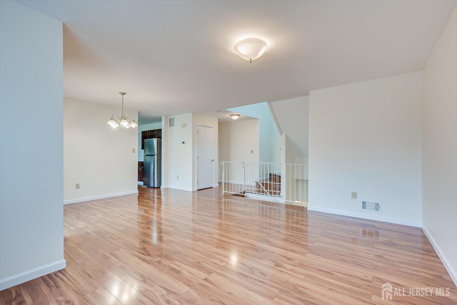 919 Plymouth Road North Brunswick, NJ 08902 - Photo 9 of 33 a view of an empty room with wooden floor