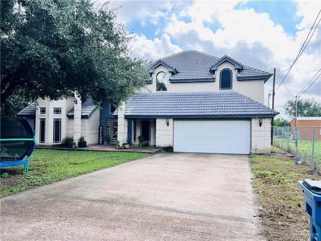 a front view of a house with a garden and deck