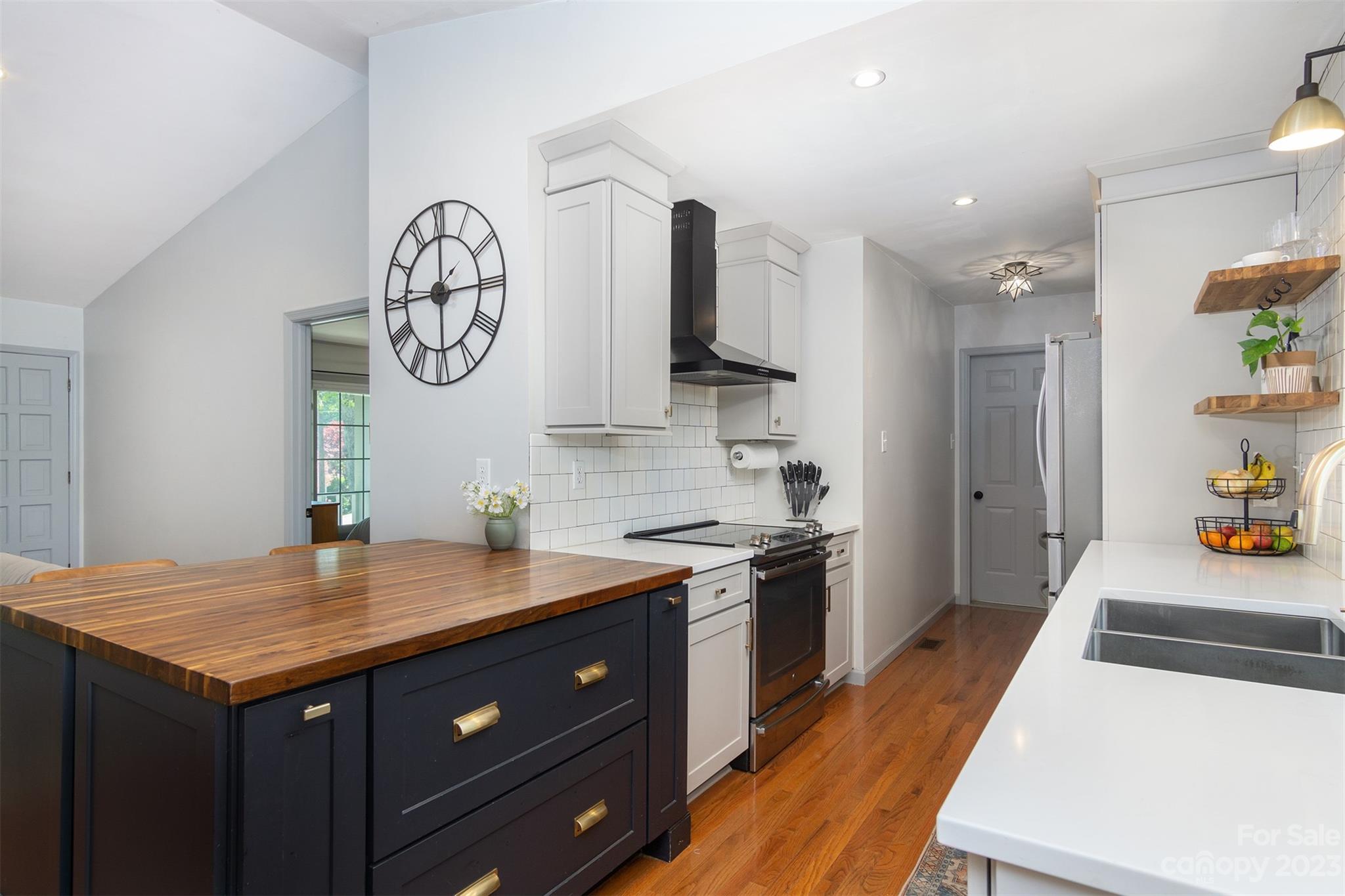 13 Woodfield Road Arden, NC 28704 - Photo 11 of 41 a kitchen with a sink a stove cabinets and wooden floor