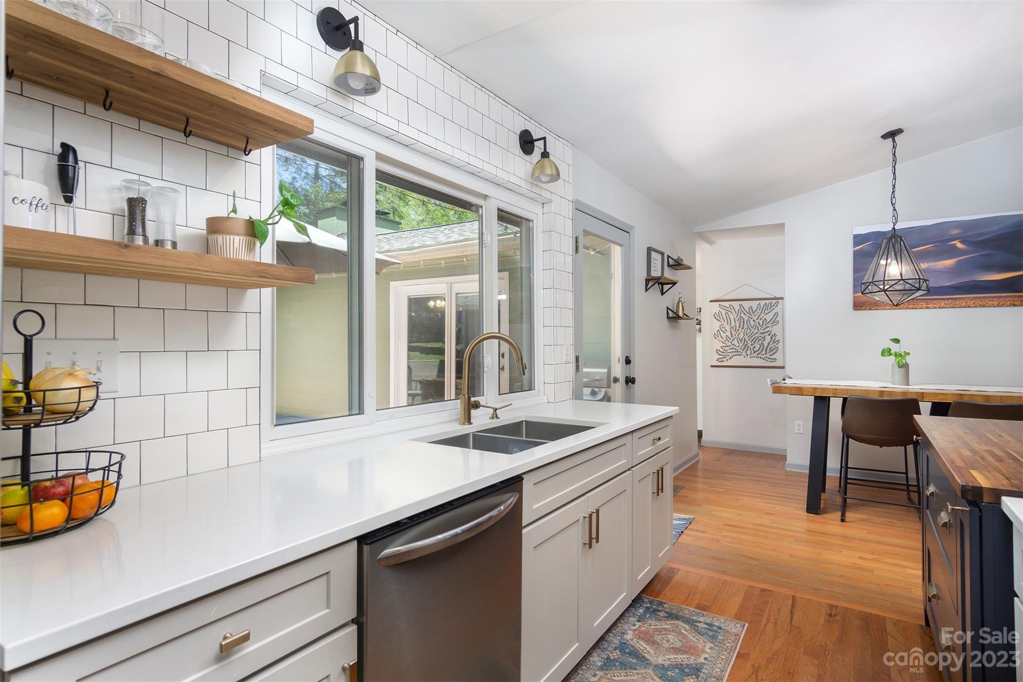 13 Woodfield Road Arden, NC 28704 - Photo 14 of 41 a kitchen with stainless steel appliances granite countertop a sink a stove and a wooden floors