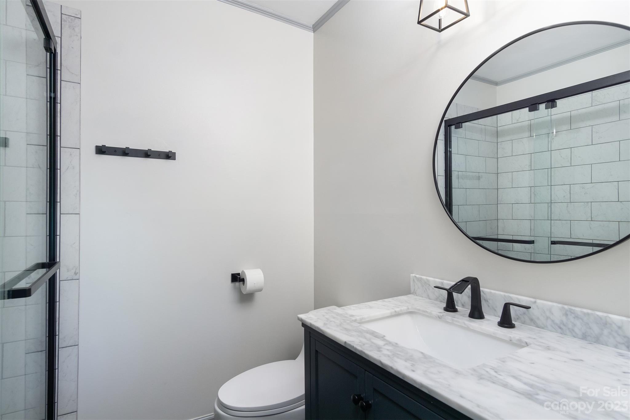 13 Woodfield Road Arden, NC 28704 - Photo 17 of 41 a bathroom with a granite countertop sink mirror and toilet