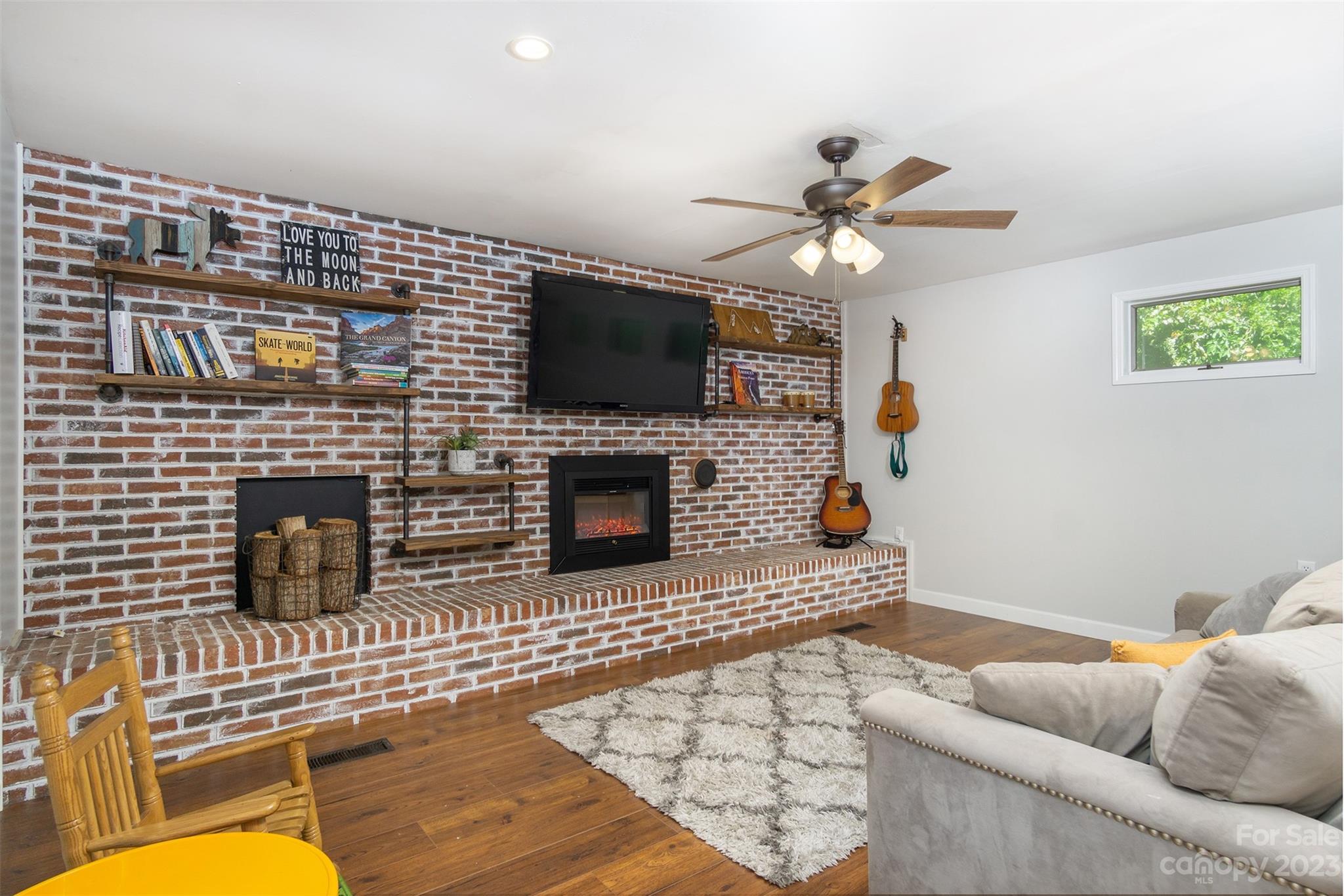 13 Woodfield Road Arden, NC 28704 - Photo 19 of 41 a living room with furniture a flat screen tv and a fireplace