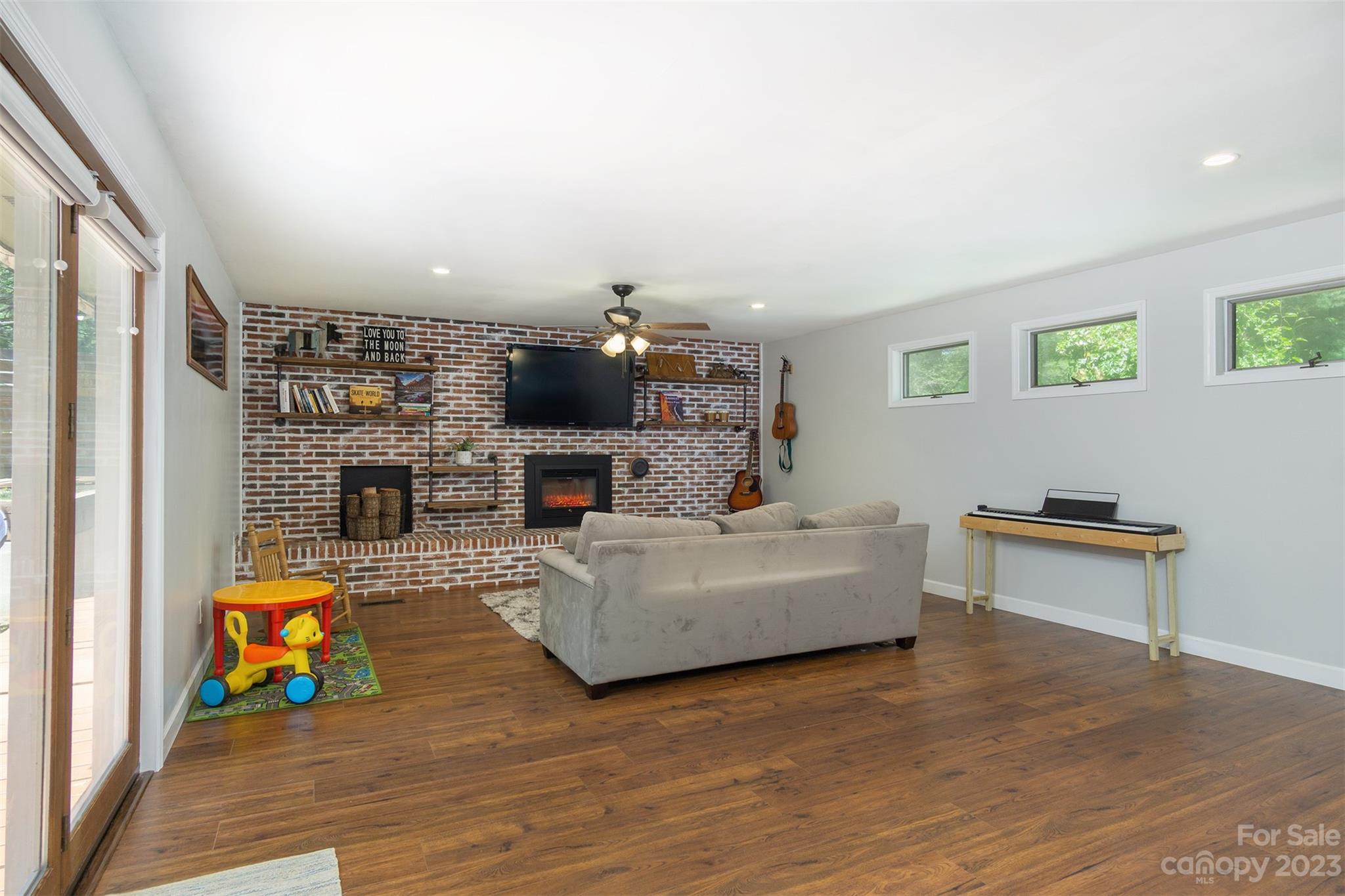 13 Woodfield Road Arden, NC 28704 - Photo 20 of 41 a living room with furniture and a wooden floor