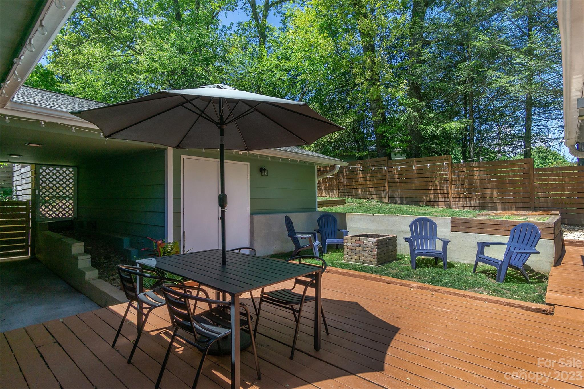 13 Woodfield Road Arden, NC 28704 - Photo 28 of 41 an outdoor space with furniture and umbrella