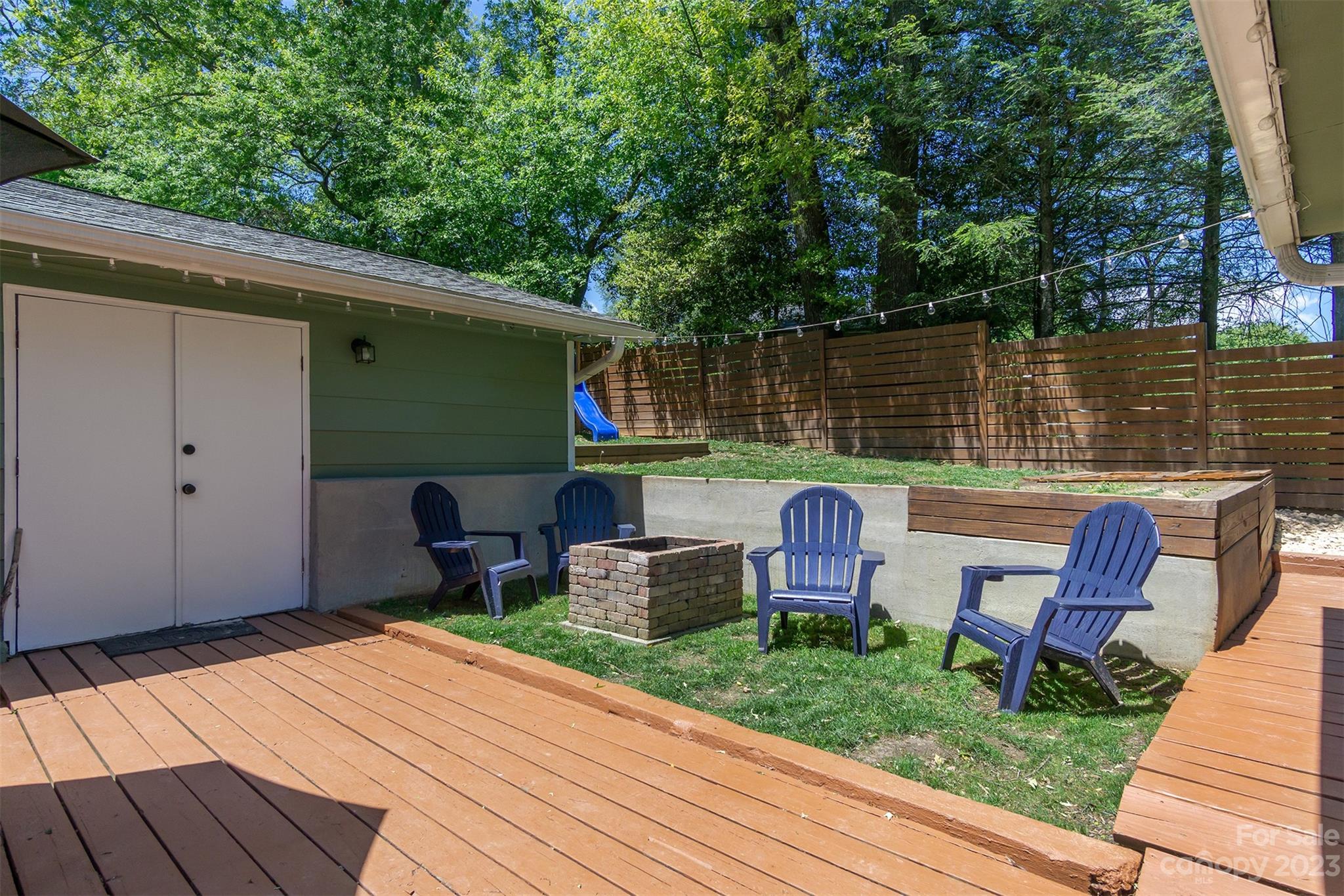 13 Woodfield Road Arden, NC 28704 - Photo 31 of 41 a backyard of a house with seating space