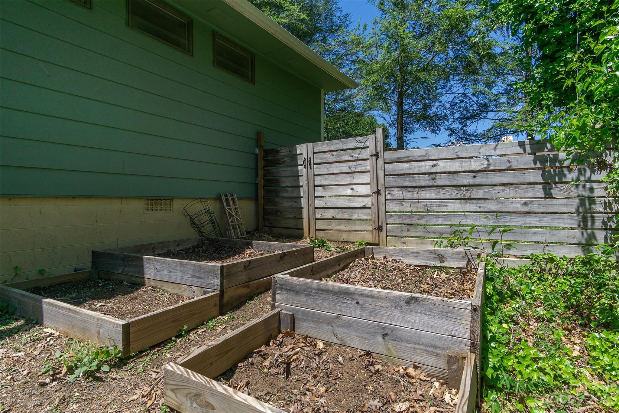 13 Woodfield Road Arden, NC 28704 - Photo 37 of 41 a view of a backyard with chairs and a fire pit