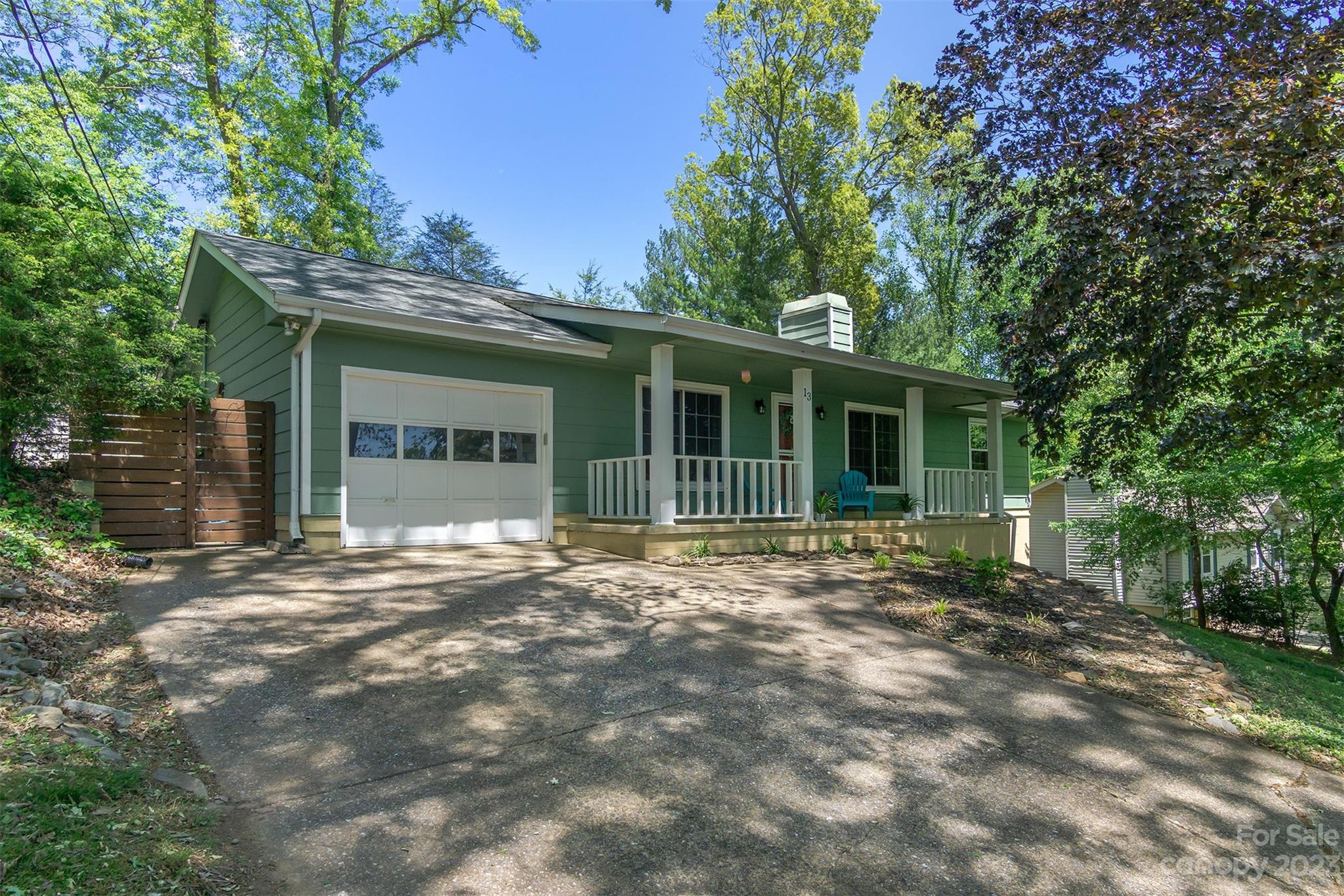 13 Woodfield Road Arden, NC 28704 - Photo 4 of 41 a front view of a house with a garden