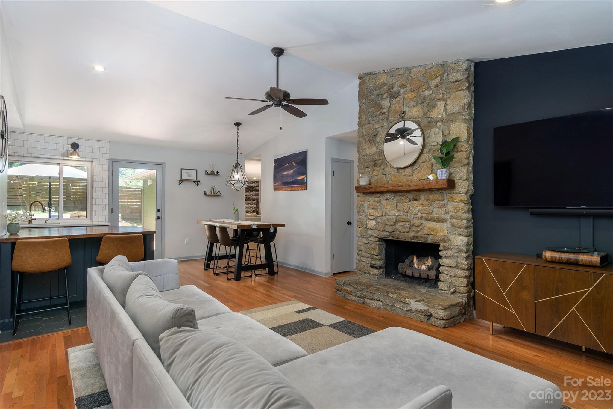 13 Woodfield Road Arden, NC 28704 - Photo 7 of 41 a living room with furniture a flat screen tv and a fireplace