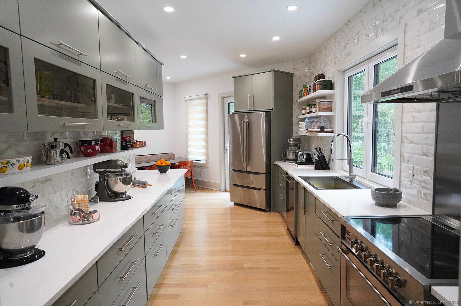 9 Grey Fox Lane Weston, CT 06883 - Photo 13 of 37 a large kitchen with stainless steel appliances a sink dishwasher a refrigerator and a dining table with wooden floor