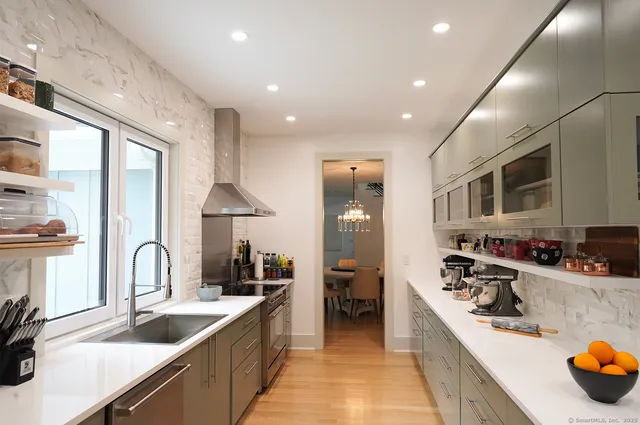 a kitchen with sink stove and cabinets