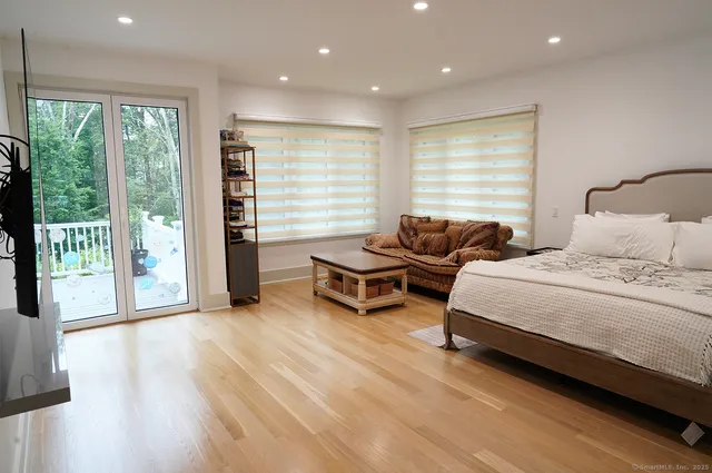 a spacious bedroom with a bed and a couch