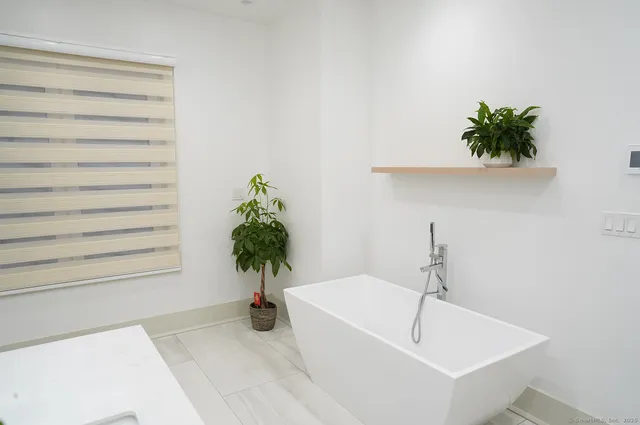 a white bath tub with a shower