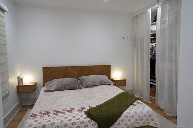 a bedroom with a bed and a lamp