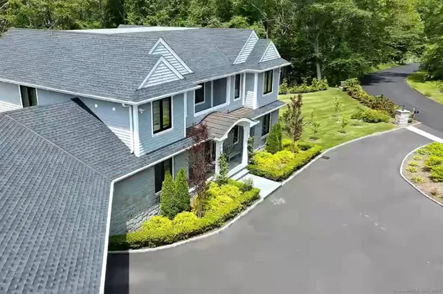 a aerial view of a house with swimming pool and garden