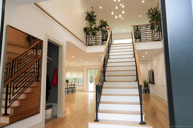 a view of entryway and hall with wooden floor